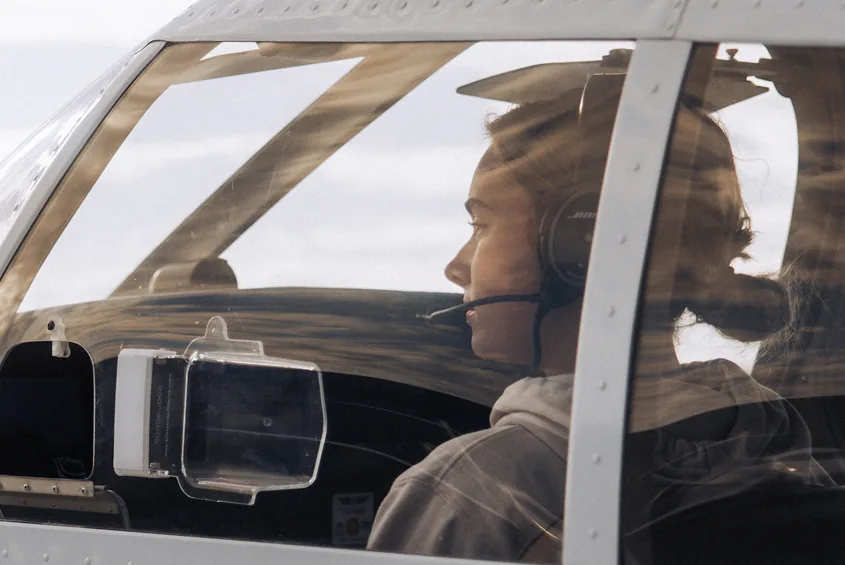 A Venture West pilot seated at the airplane controls