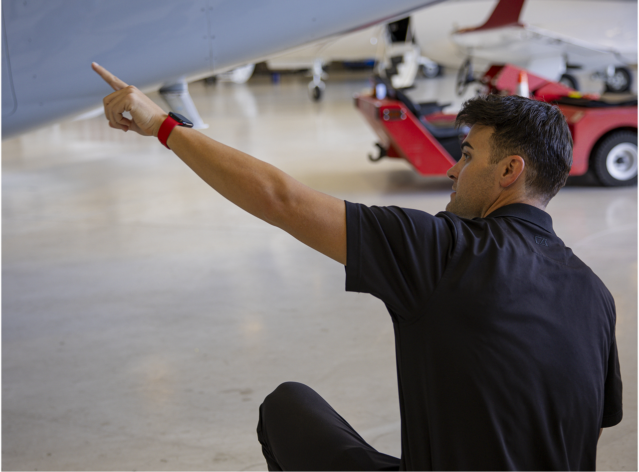 Aviation professional inspecting aircraft in hangar