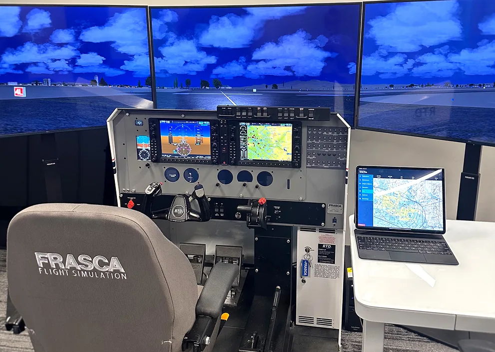 A flight simulator with instrument displays and three surrounding screens.